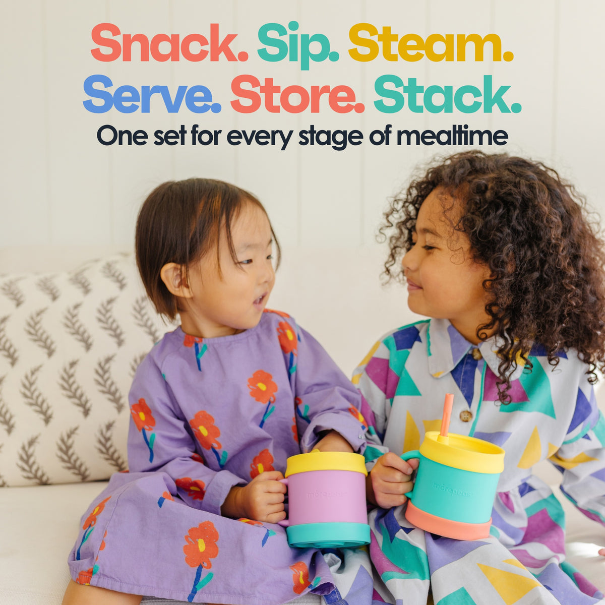 Two toddlers holding Morepeas cups with sippy and snack lids